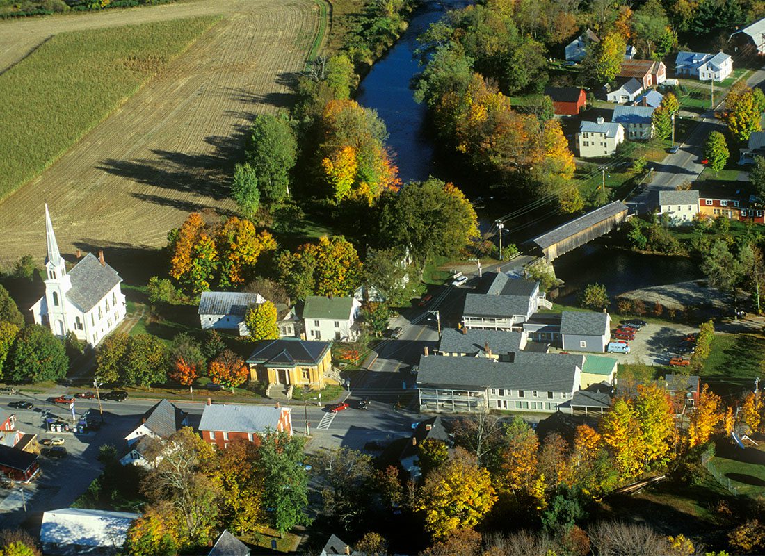Billerica, MA - Aerial View of a Church and Homes Surrounded by Green and Colorful Fall Foliage on a Sunny Day in the Small Town of Billerica Massachusetts